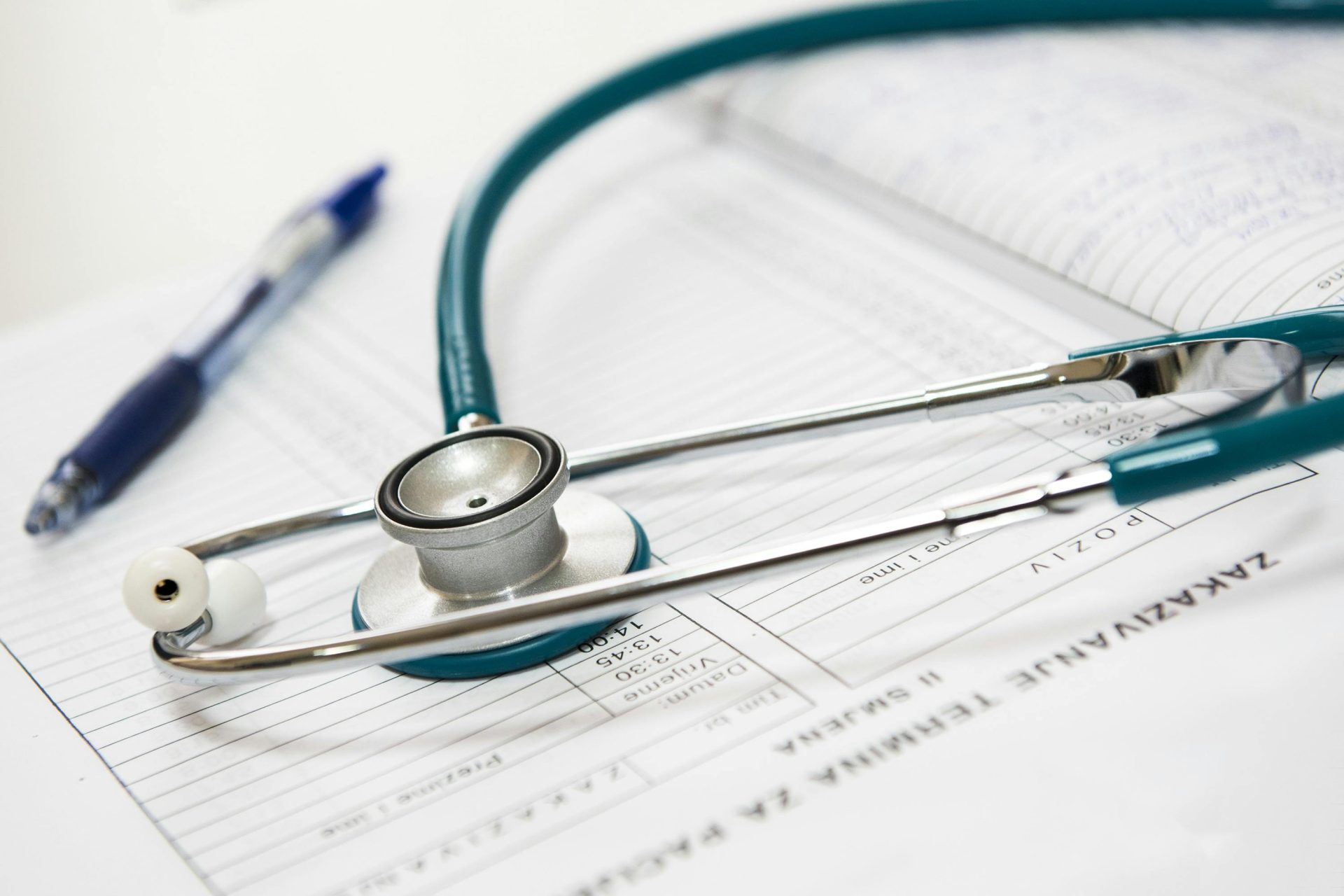 Stethoscope lying on medical records paper.