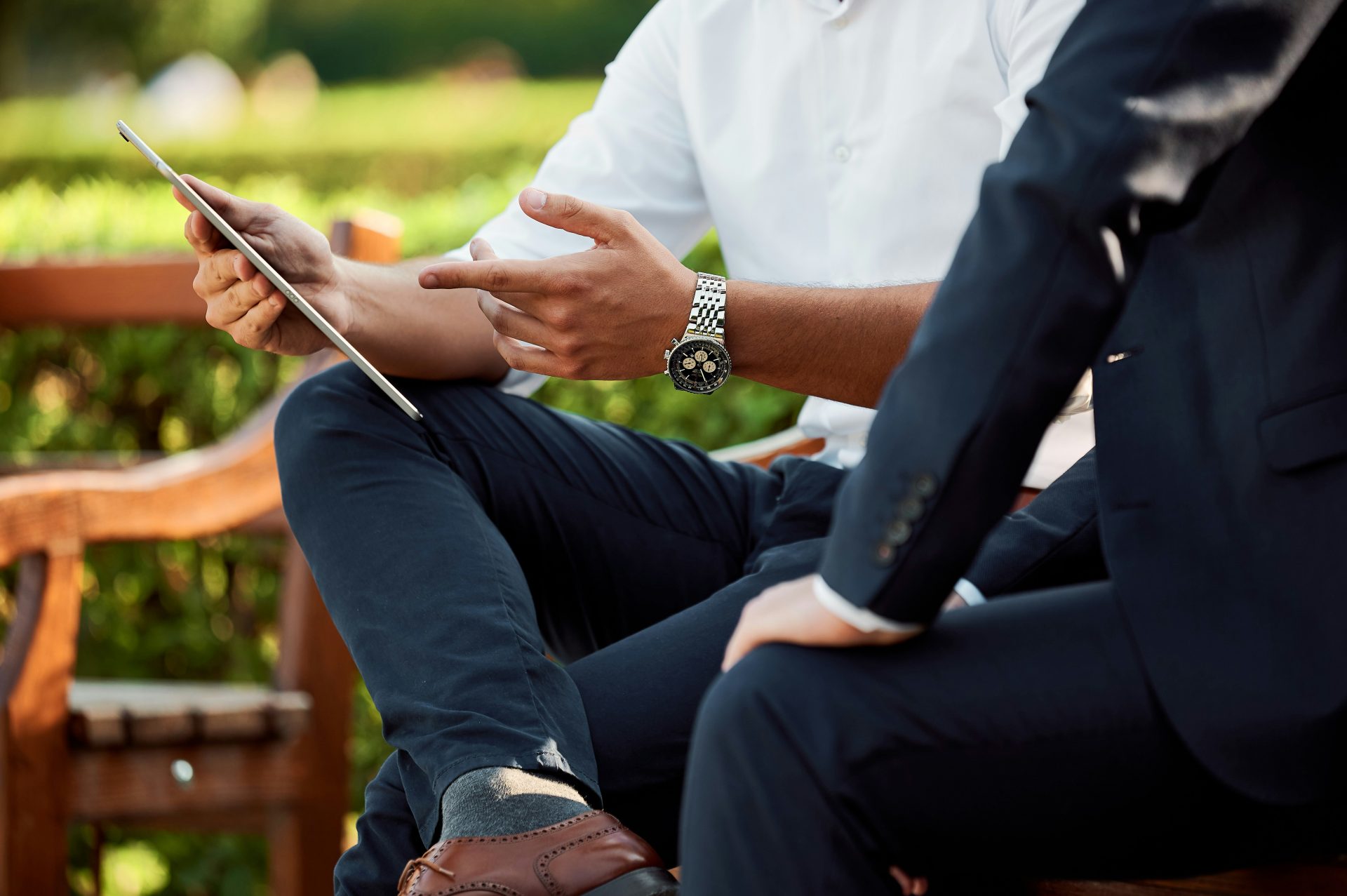 Two professionals discussing ideas with tablet.